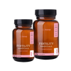 Two bottles of 'Fertility Essentials' supplements by Strime on a transparent background